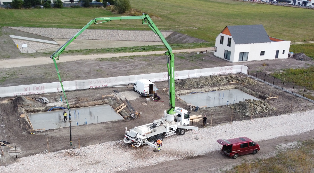 Betonowanie płyt fundamentowych obu budynków przy użyciu pompy do betonu.